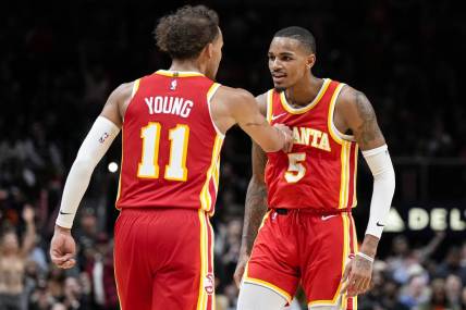 Oct 30, 2023; Atlanta, Georgia, USA; Atlanta Hawks guards Trae Young (11) and Dejounte Murray (5) react after a basket against the Minnesota Timberwolves during the second half at State Farm Arena. Mandatory Credit: Dale Zanine-USA TODAY Sports