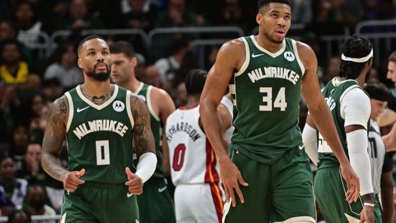 Oct 30, 2023; Milwaukee, Wisconsin, USA; Milwaukee Bucks forward Giannis Antetokounmpo (34) and guard Damian Lillard (0) looks on during a timeout in the fourth quarter against the Miami Heat at Fiserv Forum. Mandatory Credit: Benny Sieu-USA TODAY Sports