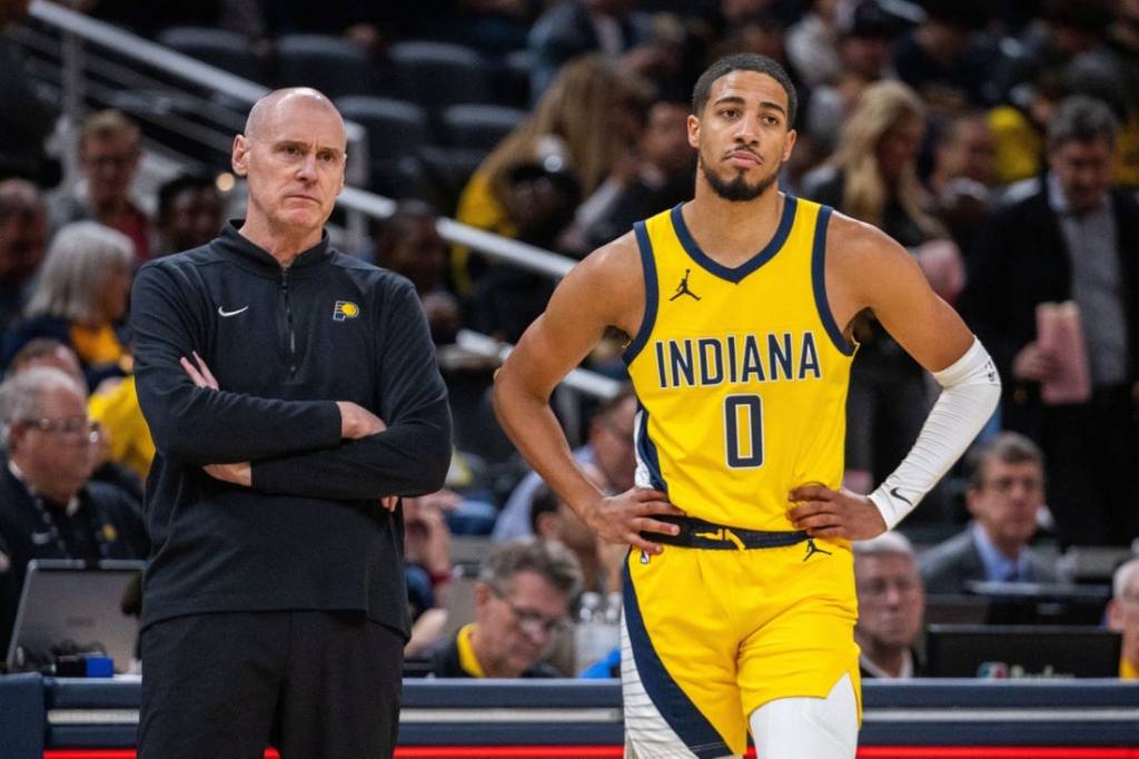 Oct 30, 2023; Indianapolis, Indiana, USA; Indiana Pacers head coach Rick Carlisle and guard Tyrese Haliburton (0) look on in the second half against the Chicago Bulls at Gainbridge Fieldhouse. Mandatory Credit: Trevor Ruszkowski-USA TODAY Sports