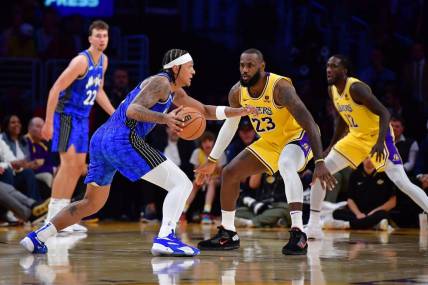 Oct 30, 2023; Los Angeles, California, USA; Orlando Magic forward Paolo Banchero (5) moves the all against Los Angeles Lakers forward LeBron James (23) during the second half at Crypto.com Arena. Mandatory Credit: Gary A. Vasquez-USA TODAY Sports