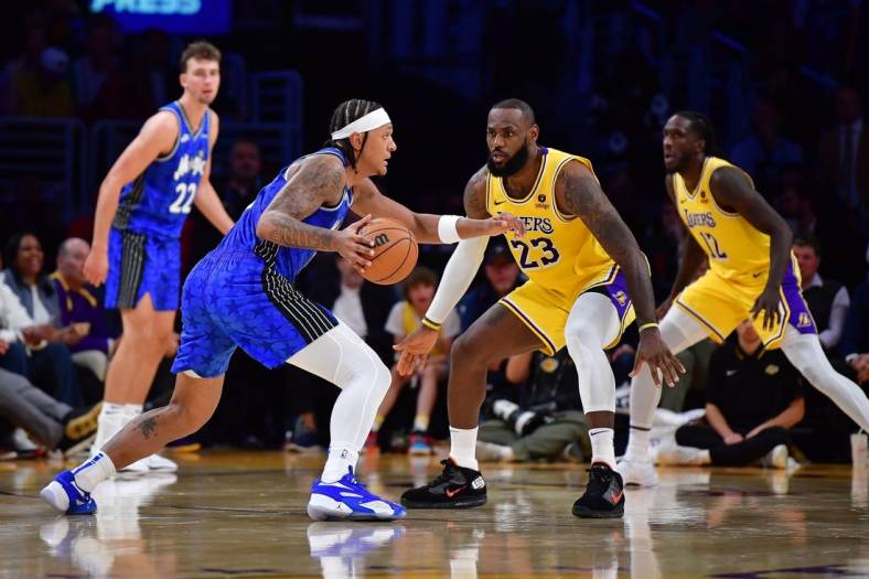 Oct 30, 2023; Los Angeles, California, USA; Orlando Magic forward Paolo Banchero (5) moves the all against Los Angeles Lakers forward LeBron James (23) during the second half at Crypto.com Arena. Mandatory Credit: Gary A. Vasquez-USA TODAY Sports