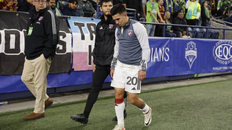 Oct 30, 2023; Seattle, Washington, USA; FC Dallas midfielder Alan Velasco (20) leaves the field after being injured in the first half against the Seattle Sounders FC in game one of a round one match of the 2023 MLS Cup Playoffs at Lumen Field. Mandatory Credit: Joe Nicholson-USA TODAY Sports