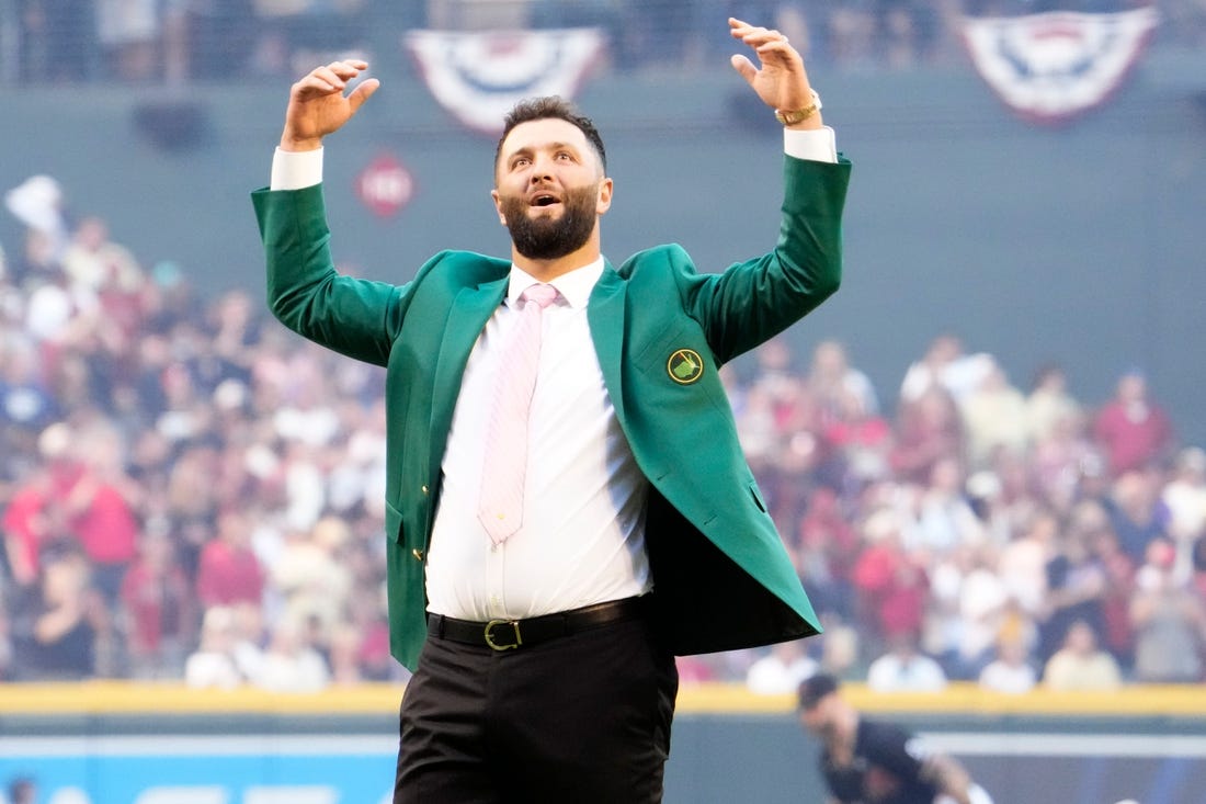 Spanish professional golfer and Arizona State University alumnus Jon Rahm reacts after throwing out the ceremonial first pitch before Game 4 of the World Series between the Arizona Diamondbacks and Texas Rangers at Chase Field in Phoenix on October 31, 2023. The DBacks lost to the Rangers 11-7, putting the Ranger at 3-1 in the World Series.