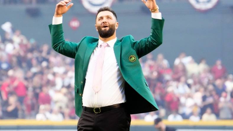 Spanish professional golfer and Arizona State University alumnus Jon Rahm reacts after throwing out the ceremonial first pitch before Game 4 of the World Series between the Arizona Diamondbacks and Texas Rangers at Chase Field in Phoenix on October 31, 2023. The DBacks lost to the Rangers 11-7, putting the Ranger at 3-1 in the World Series.