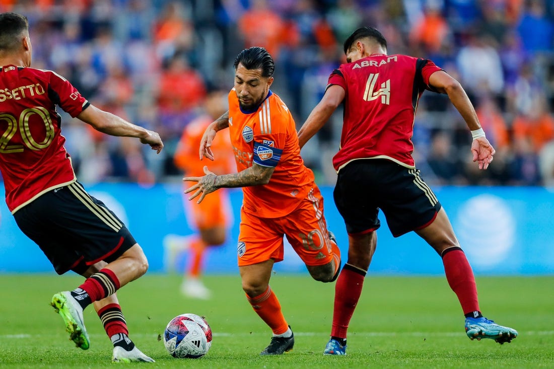 Oct 21, 2023; Cincinnati, Ohio, USA; FC Cincinnati midfielder Luciano Acosta (10) battles for the ball against Atlanta United FC midfielder Matheus Rossetto (20) and defender Luis Abram (4) in the first half at TQL Stadium. Mandatory Credit: Katie Stratman-USA TODAY Sports