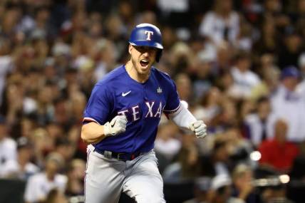 Nov 1, 2023; Phoenix, Arizona, USA; Texas Rangers catcher Mitch Garver (18) reacts after hitting a RBI single against the Arizona Diamondbacks during the sixth inning in game five of the 2023 World Series at Chase Field. Mandatory Credit: Mark J. Rebilas-USA TODAY Sports