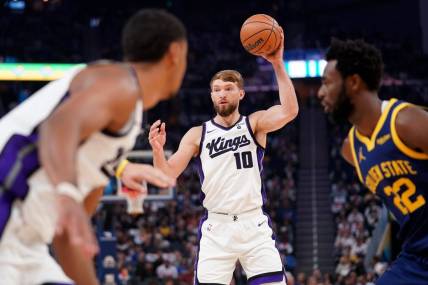 Nov 1, 2023; San Francisco, California, USA; Sacramento Kings forward Domantas Sabonis (10) holds onto the ball against the Golden State Warriors in the first quarter at the Chase Center. Mandatory Credit: Cary Edmondson-USA TODAY Sports