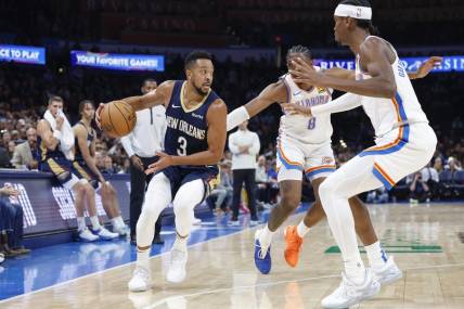 Nov 1, 2023; Oklahoma City, Oklahoma, USA; New Orleans Pelicans guard CJ McCollum (3) drives down the court against Oklahoma City Thunder forward Jalen Williams (8) and guard Shai Gilgeous-Alexander (2) during the second half at Paycom Center. New Orleans won 110-106. Mandatory Credit: Alonzo Adams-USA TODAY Sports