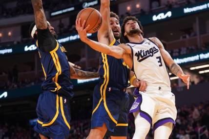 Nov 1, 2023; San Francisco, California, USA; Sacramento Kings guard Chris Duarte (3) is fouled by Golden State Warriors guard Klay Thompson (11) in the second quarter at the Chase Center. Mandatory Credit: Cary Edmondson-USA TODAY Sports.