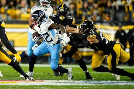 Tennessee Titans running back Tyjae Spears (32) runs the ball past Pittsburgh Steelers linebacker Cole Holcomb (55) during the first quarter in Pittsburgh, Pa., Thursday, Nov. 2, 2023.