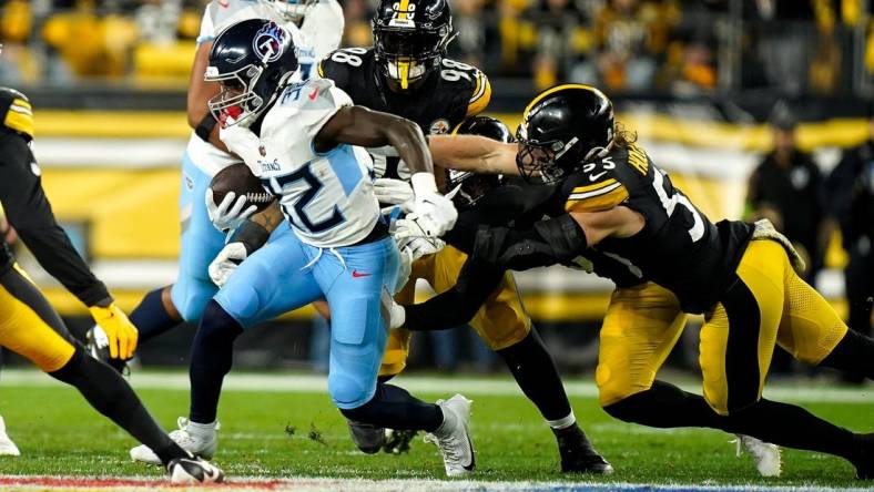 Tennessee Titans running back Tyjae Spears (32) runs the ball past Pittsburgh Steelers linebacker Cole Holcomb (55) during the first quarter in Pittsburgh, Pa., Thursday, Nov. 2, 2023.