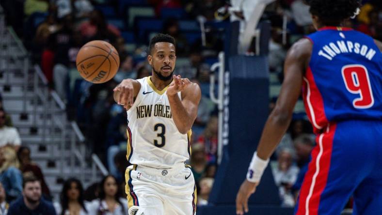 Nov 2, 2023; New Orleans, Louisiana, USA;  New Orleans Pelicans guard CJ McCollum (3) passes around Detroit Pistons forward Ausar Thompson (9) during the first half at the Smoothie King Center. Mandatory Credit: Stephen Lew-USA TODAY Sports