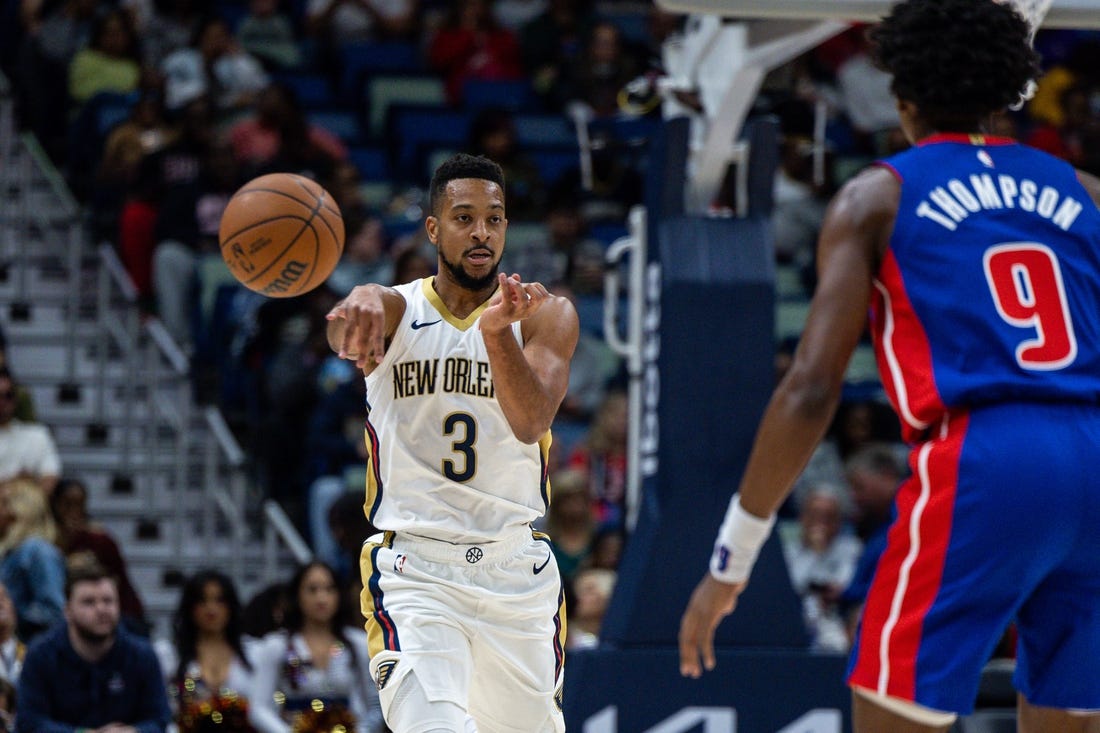Nov 2, 2023; New Orleans, Louisiana, USA;  New Orleans Pelicans guard CJ McCollum (3) passes around Detroit Pistons forward Ausar Thompson (9) during the first half at the Smoothie King Center. Mandatory Credit: Stephen Lew-USA TODAY Sports