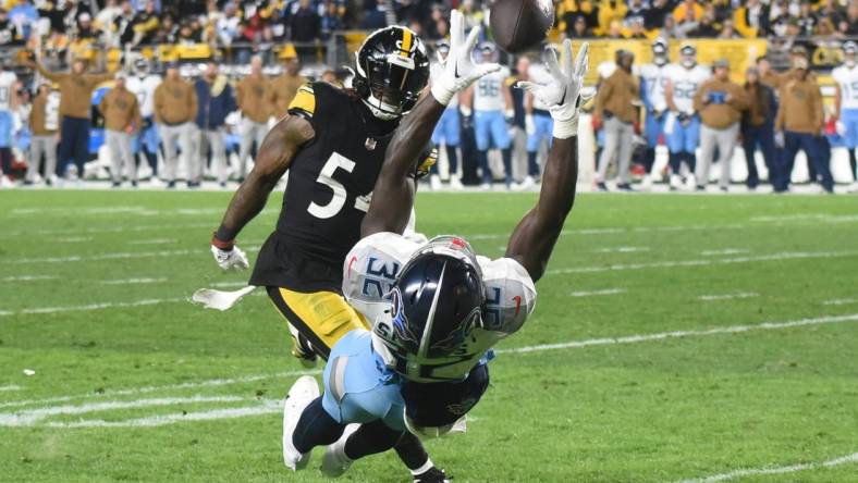 Nov 2, 2023; Pittsburgh, Pennsylvania, USA; The ball goes through hands of Tennessee Titans running back Tyjae Spears (32) as Pittsburgh Steelers linebacker Kwon Alexander (54) applies coverage during the second quarter at Acrisure Stadium. Mandatory Credit: Philip G. Pavely-USA TODAY Sports