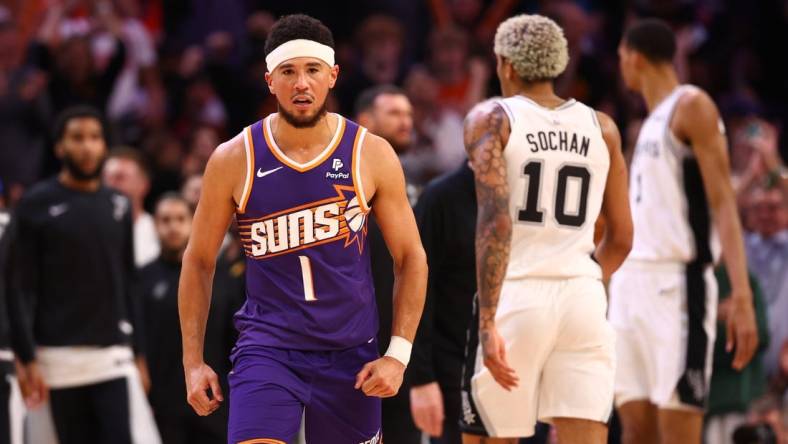 Nov 2, 2023; Phoenix, Arizona, USA; Phoenix Suns guard Devin Booker (1) celebrates a shot against the San Antonio Spurs in the second half at Footprint Center. Mandatory Credit: Mark J. Rebilas-USA TODAY Sports