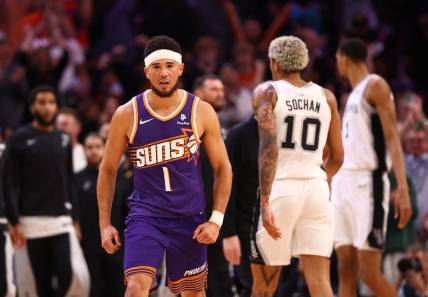 Nov 2, 2023; Phoenix, Arizona, USA; Phoenix Suns guard Devin Booker (1) celebrates a shot against the San Antonio Spurs in the second half at Footprint Center. Mandatory Credit: Mark J. Rebilas-USA TODAY Sports
