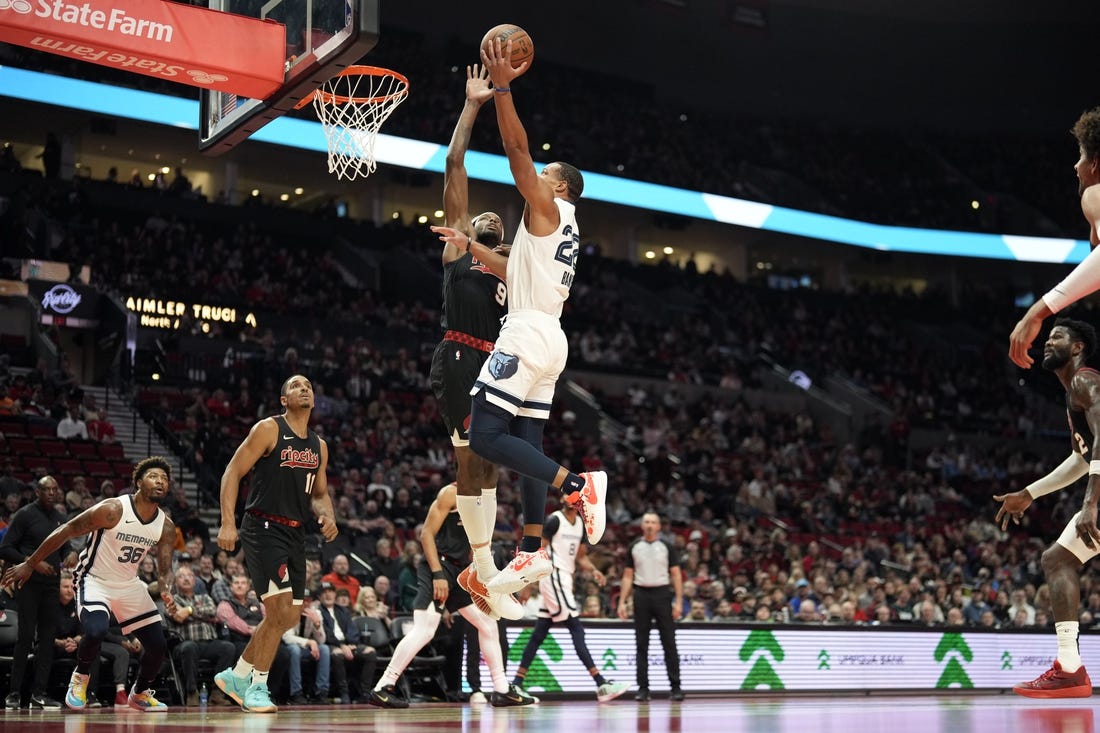 Nov 3, 2023; Portland, Oregon, USA; Memphis Grizzlies shooting guard Desmond Bane (22) shoots under pressure from Portland Trail Blazers small forward Jerami Grant (9) during the first half at Moda Center. Mandatory Credit: Soobum Im-USA TODAY Sports