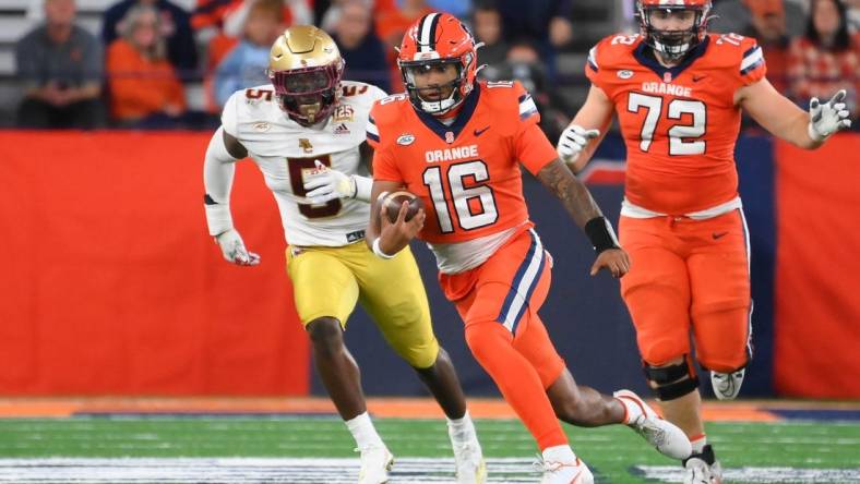 Nov 3, 2023; Syracuse, New York, USA; Syracuse Orange quarterback Carlos Del Rio-Wilson (16) runs as Boston College Eagles linebacker Kam Arnold (5) chases during the second half at the JMA Wireless Dome. Mandatory Credit: Rich Barnes-USA TODAY Sports