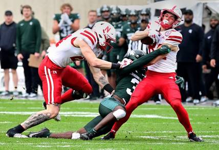 Nov 4, 2023; East Lansing, Michigan, USA;  Michigan State Spartans defensive back Caleb Coley (3) tackles Nebraska Cornhuskers wide receiver Alex Bullock (84) in spite of  tight end Thomas Fidone II (24) at Spartan Stadium. Mandatory Credit: Dale Young-USA TODAY Sports