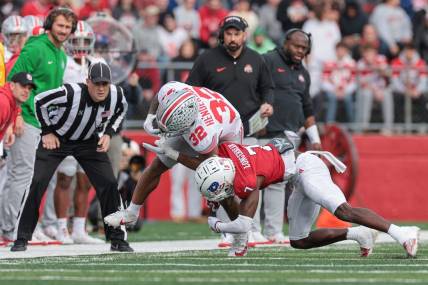 Nov 4, 2023; Piscataway, New Jersey, USA; Ohio State Buckeyes running back TreVeyon Henderson (32) is tackled by Rutgers Scarlet Knights defensive back Robert Longerbeam (7) during the first half at SHI Stadium. Mandatory Credit: Vincent Carchietta-USA TODAY Sports