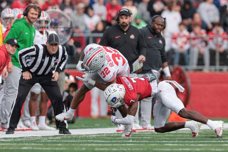 Nov 4, 2023; Piscataway, New Jersey, USA; Ohio State Buckeyes running back TreVeyon Henderson (32) is tackled by Rutgers Scarlet Knights defensive back Robert Longerbeam (7) during the first half at SHI Stadium. Mandatory Credit: Vincent Carchietta-USA TODAY Sports