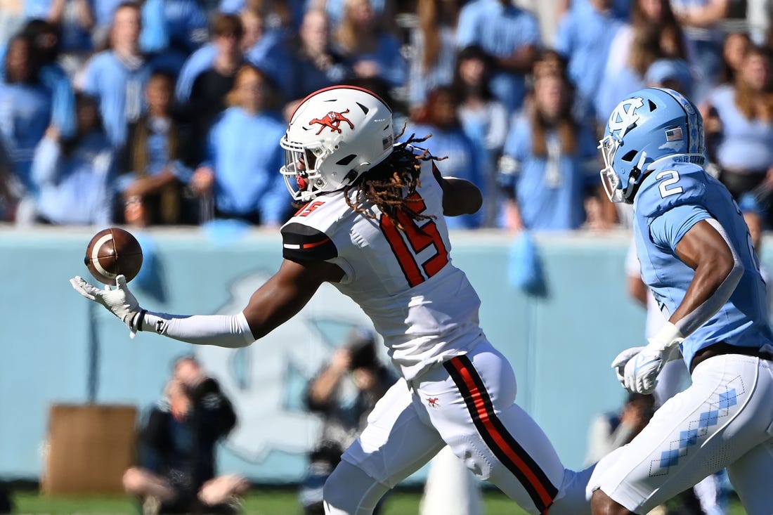 Nov 4, 2023; Chapel Hill, North Carolina, USA; Campbell Fighting Camels tight end Javonte Kinsey (15) catches the ball as North Carolina Tar Heels defensive back Don Chapman (2) defends in the first quarter at Kenan Memorial Stadium. Mandatory Credit: Bob Donnan-USA TODAY Sports