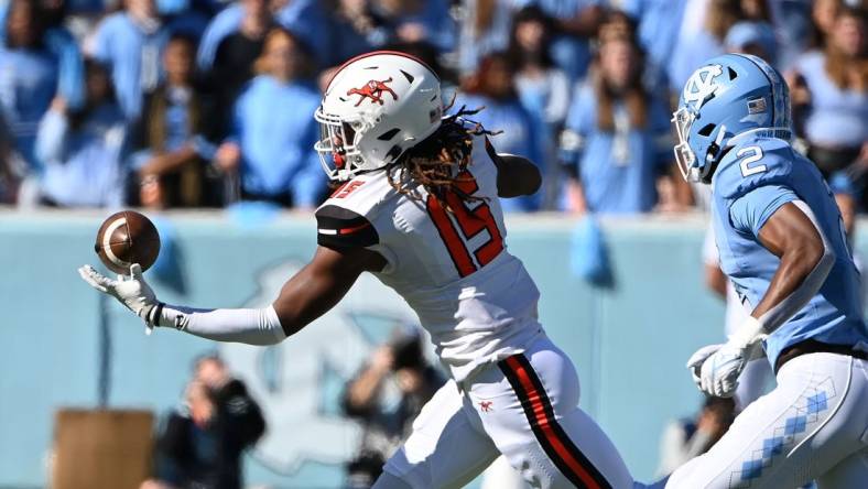 Nov 4, 2023; Chapel Hill, North Carolina, USA; Campbell Fighting Camels tight end Javonte Kinsey (15) catches the ball as North Carolina Tar Heels defensive back Don Chapman (2) defends in the first quarter at Kenan Memorial Stadium. Mandatory Credit: Bob Donnan-USA TODAY Sports