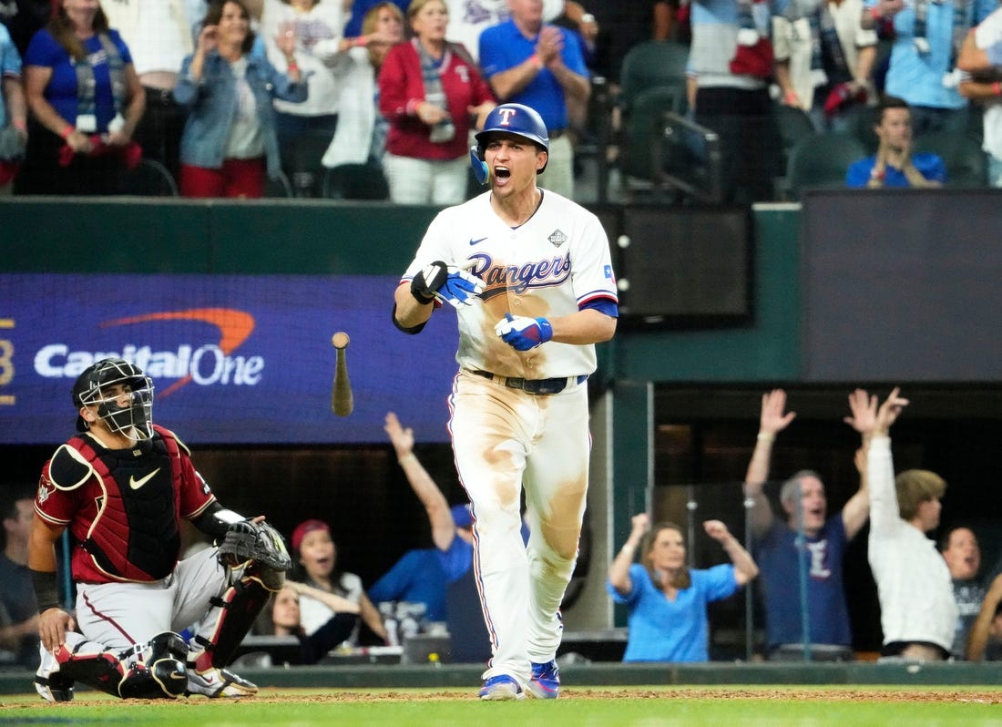 Oct 27, 2023; Arlington, Texas, USA; Texas Rangers Corey Seager (5) hits a two-run home run off Arizona Diamondbacks relief pitcher Paul Sewald (38) in the ninth inning during Game 1 of 2023 World Series at Globe Life Field. Mandatory Credit: Rob Schumacher-Arizona Republic