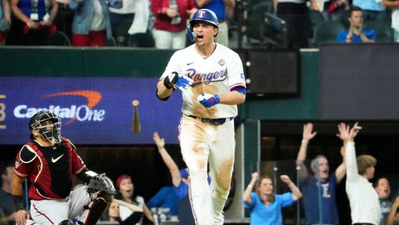 Oct 27, 2023; Arlington, Texas, USA; Texas Rangers Corey Seager (5) hits a two-run home run off Arizona Diamondbacks relief pitcher Paul Sewald (38) in the ninth inning during Game 1 of 2023 World Series at Globe Life Field. Mandatory Credit: Rob Schumacher-Arizona Republic