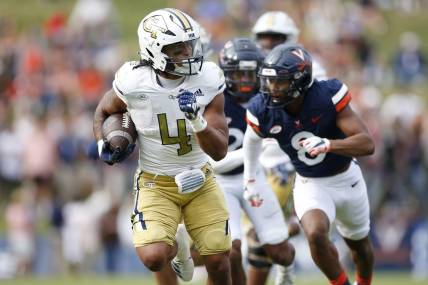 Nov 4, 2023; Charlottesville, Virginia, USA; Georgia Tech Yellow Jackets running back Dontae Smith (4) carries the to score a touchdown during the first half against the Virginia Cavaliers at Scott Stadium. Mandatory Credit: Amber Searls-USA TODAY Sports