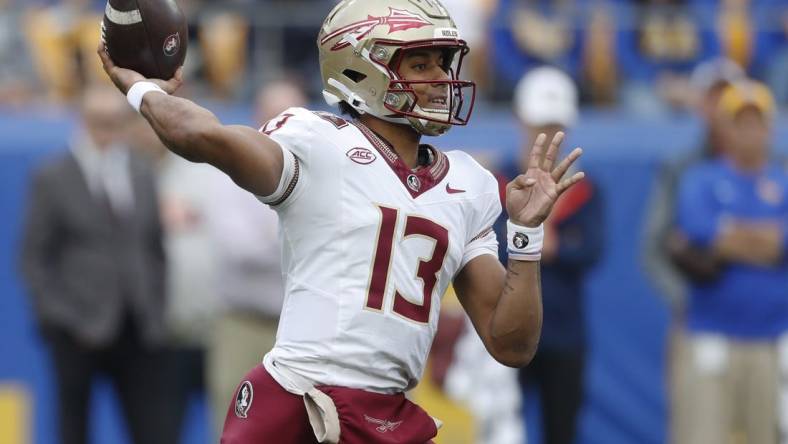 Nov 4, 2023; Pittsburgh, Pennsylvania, USA;  Florida State Seminoles quarterback Jordan Travis (13) passes the ball against the Pittsburgh Panthers during the first quarter at Acrisure Stadium. Mandatory Credit: Charles LeClaire-USA TODAY Sports