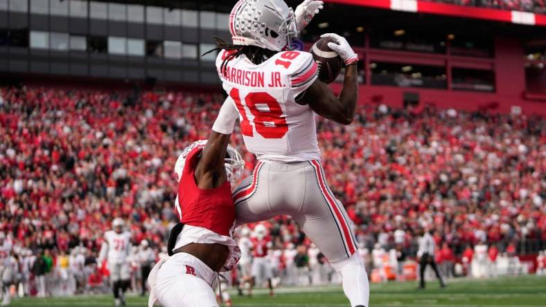 Nov 4, 2023; Piscataway, New Jersey, USA; Ohio State Buckeyes wide receiver Marvin Harrison Jr. (18) catches a 4-yard touchdown in front of Rutgers Scarlet Knights defensive back Robert Longerbeam (7) during the second half of the NCAA football game at SHI Stadium. Ohio State won 35-16.