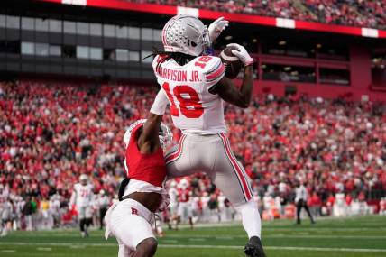Nov 4, 2023; Piscataway, New Jersey, USA; Ohio State Buckeyes wide receiver Marvin Harrison Jr. (18) catches a 4-yard touchdown in front of Rutgers Scarlet Knights defensive back Robert Longerbeam (7) during the second half of the NCAA football game at SHI Stadium. Ohio State won 35-16.