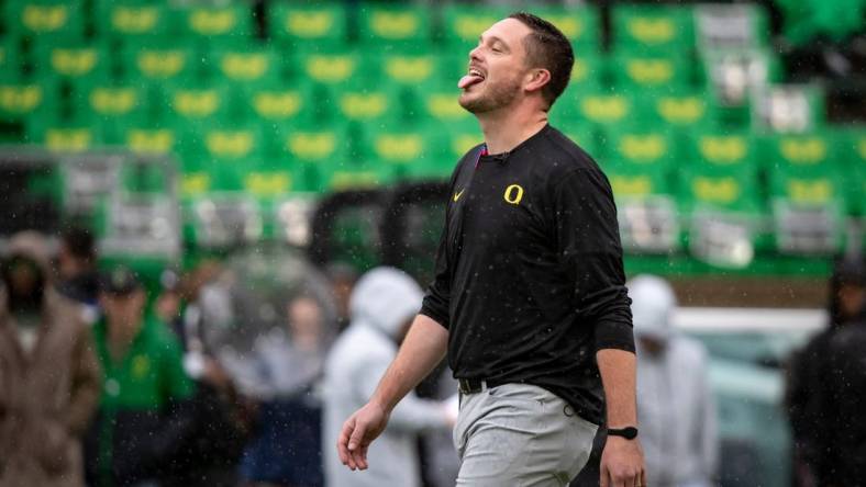 Oregon head coach Dan Lanning sticks his tongue out to catch the rain as the No. 6 Oregon Ducks host California Saturday, Nov. 4, 2023, at Autzen Stadium in Eugene, Ore.