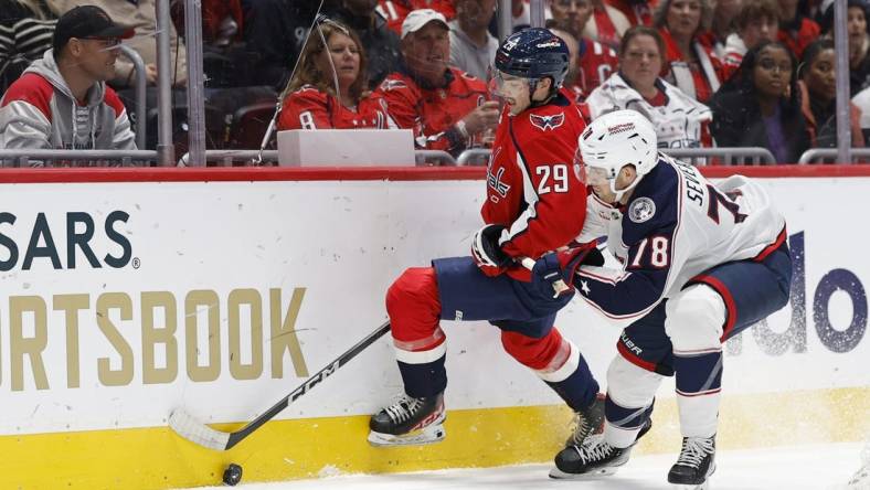 Nov 4, 2023; Washington, District of Columbia, USA; Washington Capitals center Hendrix Lapierre (29) and Columbus Blue Jackets defenseman Damon Severson (78) battle for the puck in the first period at Capital One Arena. Mandatory Credit: Geoff Burke-USA TODAY Sports