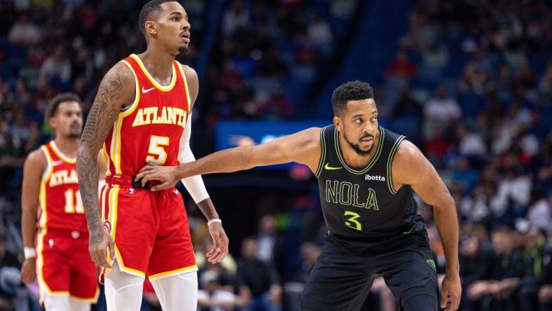 Nov 4, 2023; New Orleans, Louisiana, USA; New Orleans Pelicans guard CJ McCollum (3) guards Atlanta Hawks guard Dejounte Murray (5) during the first half at Smoothie King Center. Mandatory Credit: Stephen Lew-USA TODAY Sports