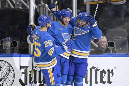 Nov 4, 2023; St. Louis, Missouri, USA; St. Louis Blues left wing Brandon Saad (20) celebrates with center Brayden Schenn (10) and St. Louis Blues center Jordan Kyrou (25) after scoring a goal against the Montreal Canadiens during the second period at Enterprise Center. Mandatory Credit: Jeff Le-USA TODAY Sports