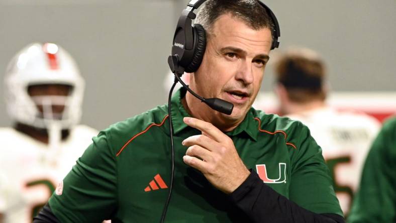 Nov 4, 2023; Raleigh, North Carolina, USA; Miami Hurricanes head coach Mario Cristobal looks on during the first half against the North Carolina State Wolfpack at Carter-Finley Stadium. Mandatory Credit: Rob Kinnan-USA TODAY Sports