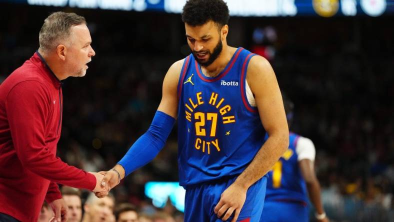 Nov 4, 2023; Denver, Colorado, USA; Denver Nuggets head coach Michael Malone checks on guard Jamal Murray (27) in the second quarter against the Chicago Bulls at Ball Arena. Mandatory Credit: Ron Chenoy-USA TODAY Sports