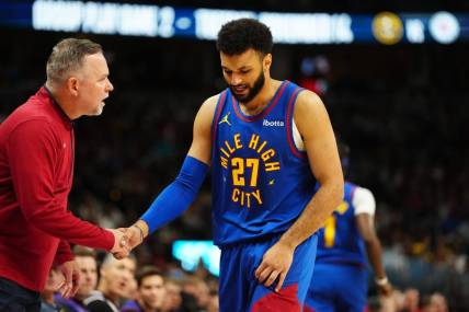 Nov 4, 2023; Denver, Colorado, USA; Denver Nuggets head coach Michael Malone checks on guard Jamal Murray (27) in the second quarter against the Chicago Bulls at Ball Arena. Mandatory Credit: Ron Chenoy-USA TODAY Sports