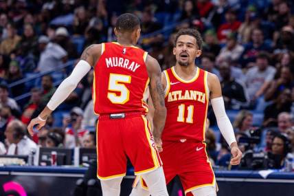 Nov 4, 2023; New Orleans, Louisiana, USA;  Atlanta Hawks guard Trae Young (11) slaps hands with guard Dejounte Murray (5) after he makes a basket against the New Orleans Pelicans during the second half at Smoothie King Center. Mandatory Credit: Stephen Lew-USA TODAY Sports