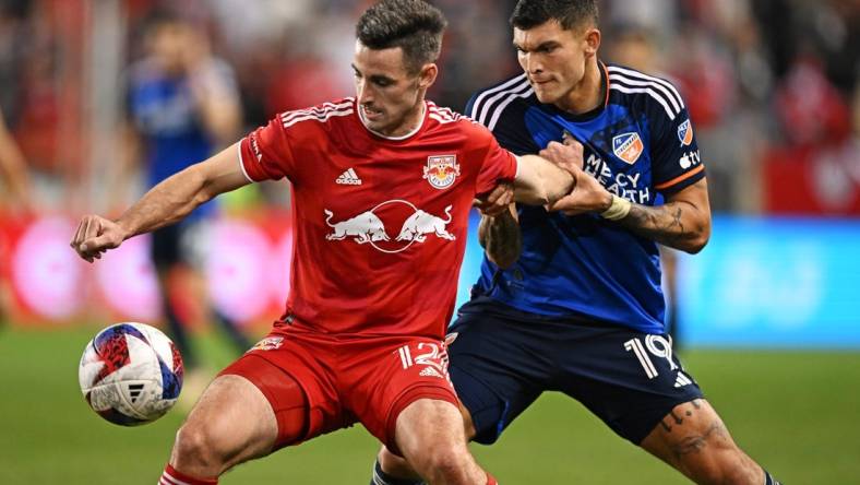 Nov 4, 2023; Harrison, NJ, USA; New York Red Bulls defender Dylan Nealis (12) and FC Cincinnati forward Brandon V  zquez (19) battle for the ball during the second half of game two in a round one match of the 2023 MLS Cup Playoffs at Red Bull Arena. Mandatory Credit: Mark Smith-USA TODAY Sports