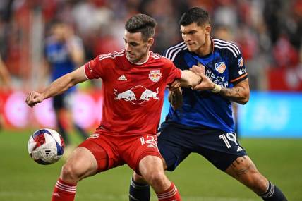 Nov 4, 2023; Harrison, NJ, USA; New York Red Bulls defender Dylan Nealis (12) and FC Cincinnati forward Brandon V  zquez (19) battle for the ball during the second half of game two in a round one match of the 2023 MLS Cup Playoffs at Red Bull Arena. Mandatory Credit: Mark Smith-USA TODAY Sports
