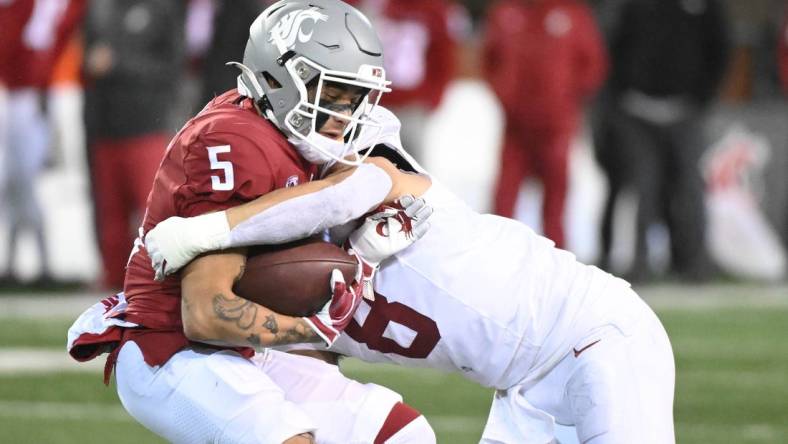 Nov 4, 2023; Pullman, Washington, USA; Washington State Cougars wide receiver Lincoln Victor (5) is stopped alert short gain by Stanford Cardinal linebacker Tristan Sinclair (8) in the second half at Gesa Field at Martin Stadium. Stanford won 10-7. Mandatory Credit: James Snook-USA TODAY Sports