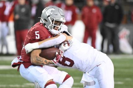Nov 4, 2023; Pullman, Washington, USA; Washington State Cougars wide receiver Lincoln Victor (5) is stopped alert short gain by Stanford Cardinal linebacker Tristan Sinclair (8) in the second half at Gesa Field at Martin Stadium. Stanford won 10-7. Mandatory Credit: James Snook-USA TODAY Sports