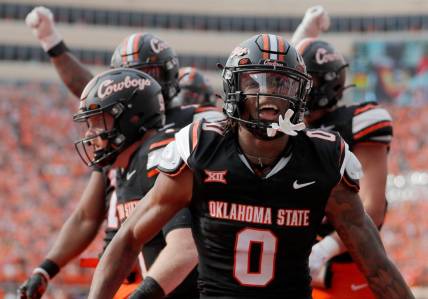 Oklahoma State's Ollie Gordon II (0) celebrates a Alan Bowman (7) touchdown in the first half during a Bedlam college football game between the Oklahoma State University Cowboys (OSU) and the University of Oklahoma Sooners (OU) at Boone Pickens Stadium in Stillwater, Okla., Saturday, Nov. 4, 2023.