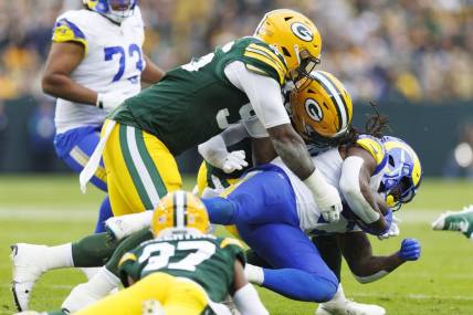 Nov 5, 2023; Green Bay, Wisconsin, USA;  Los Angeles Rams running back Darrell Henderson Jr. (27) is tackled by Green Bay Packers linebackers De'Vondre Campbell (59) and Preston Smith (91) during the second quarter at Lambeau Field. Mandatory Credit: Jeff Hanisch-USA TODAY Sports