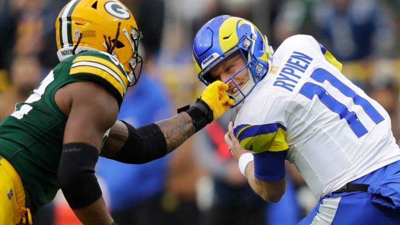 Green Bay Packers linebacker Rashan Gary (52) grabs the facemask of Los Angeles Rams quarterback Brett Rypien (11) during their football game Sunday, November 5, 2023, at Lambeau Field in Green Bay, Wis. Gary was penalized on the play.
Dan Powers/USA TODAY NETWORK-Wisconsin.