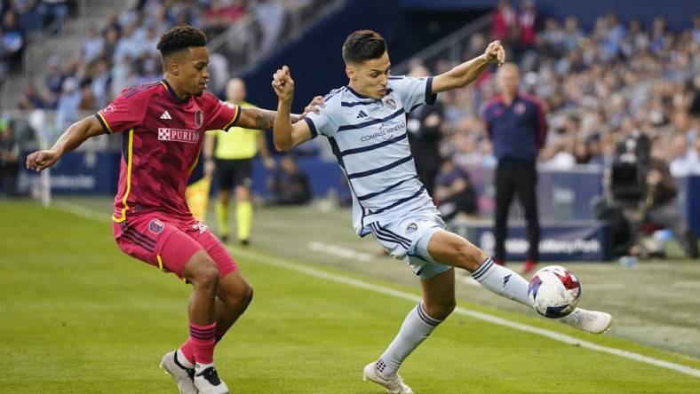 Nov 5, 2023; Kansas City, KS, USA; Sporting Kansas City forward Daniel Salloi (20) plays the ball defended by St. Louis City SC defender Akil Watts (20) in the first half of game two in a round one match of the 2023 MLS Cup Playoffs at Children's Mercy Park. Mandatory Credit: Jay Biggerstaff-USA TODAY Sports