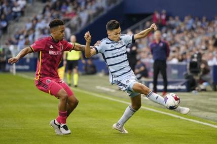 Nov 5, 2023; Kansas City, KS, USA; Sporting Kansas City forward Daniel Salloi (20) plays the ball defended by St. Louis City SC defender Akil Watts (20) in the first half of game two in a round one match of the 2023 MLS Cup Playoffs at Children's Mercy Park. Mandatory Credit: Jay Biggerstaff-USA TODAY Sports